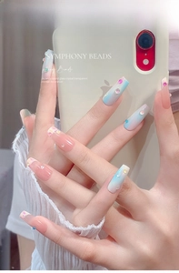 Detailed view of mermaid symphony beads and macaron pearls on long coffin press-on nails