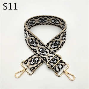Detail of adjustable ethnic style woven strap with geometric patterns and gold lobster clasps