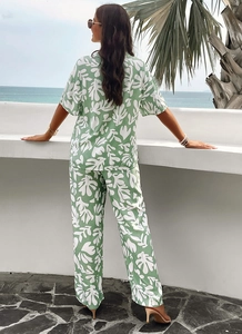 Close-up of green and white abstract print on lightweight short-sleeve shirt and trousers