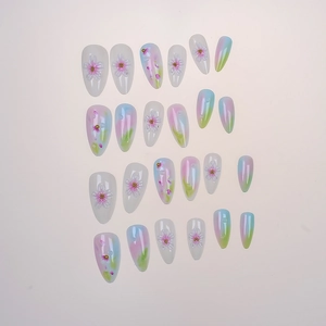 Detailed flat lay of 24pcs almond press-on nails with 3D floral accents and gradients