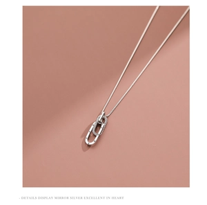 Macro detail of S925 silver interlocking rings necklace with forever engraving and zircon stones
