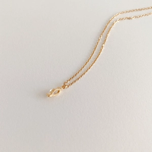 Macro detail of marquise-cut zircon pendant on gold-plated S925 sterling silver chain