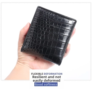 Macro shot showing the soft texture and flexible leather of this black crocodile wallet
