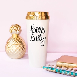 Detailed view of Boss Lady white double wall travel mug with elegant gold lid and lettering