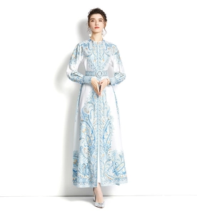 Detail of elegant stand collar with covered buttons and ornate blue paisley floral print