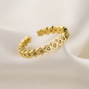Detail of 18K gold plated star ring with sparkling round cubic zirconia stone