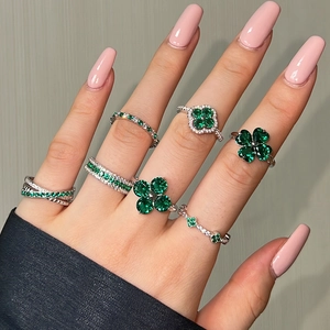 Detailed close-up of S925 silver rings with green zircon stones on model's hand