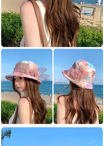 Detail of breathable summer sun hat with artistic purple print and 3D floral accent