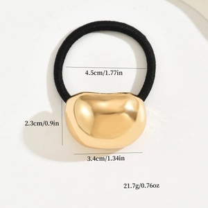 Golden heart-shaped metal hair tie with black elastic band and dimension details