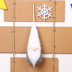 Detail of Christmas gnome plush with grey knitted hat and thick faux fur beard