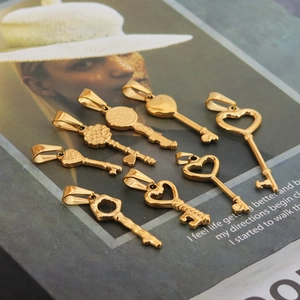 Collection of vintage gold heart-shaped key pendants on a minimalist background