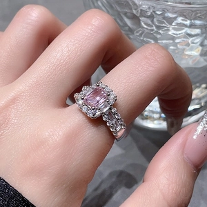 Macro view of luxurious floral ring featuring a radiant pink zircon in halo setting