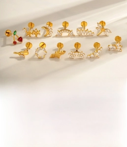 Detailed macro view of gold titanium labret studs featuring cherry and star zircon shapes