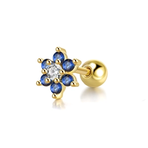 Macro view of gold flower cartilage stud with blue and clear inlaid gemstones