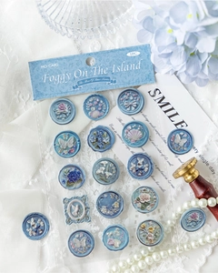 Detail view of light blue retro embossed wax seal stickers with butterfly and rose motifs