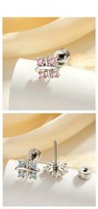 Close-up of cross geometric earrings with silver finish and small colorful gemstones