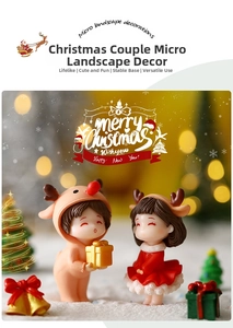 Close-up of cute Christmas couple figurines in a cozy snowy scene with glowing trees
