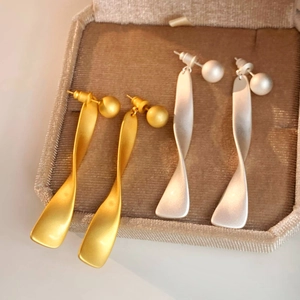 Modern twisted wave brushed metal drop earrings in gold and silver finishes