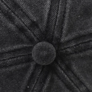 Macro view of the top button and stitched fabric seams on the washed cotton baseball cap