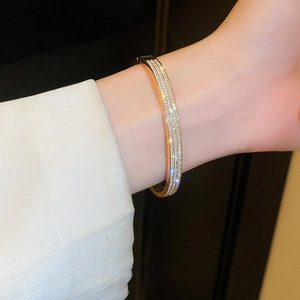 Luxury gold titanium steel bracelet featuring triple row crystal diamonds for women
