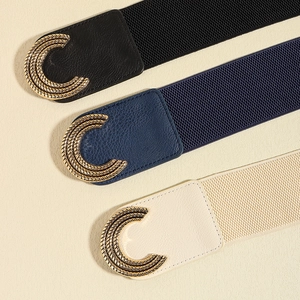 Close-up of elastic waist belts featuring gold spiral C-buckles in black, navy and beige