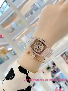 Detail of rose gold tonneau watch with rotating floral dial and iced out bracelet