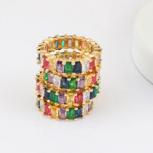 Close-up of three stacked gold rings with colorful rectangular zircon stones in detail