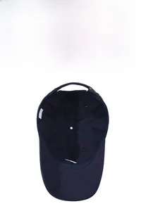 Interior detail of navy blue cotton baseball cap showing stitching and breathable eyelets