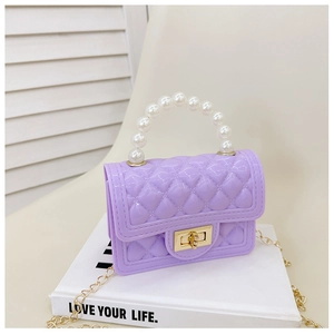 Macro shot of purple quilted jelly bag featuring pearl handle and golden twist lock detail