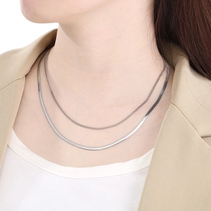 Close-up of double layer silver stainless steel snake chain and link necklace on model