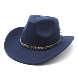 Close-up of navy wool cowboy hat with gear metal charm and woven decorative band