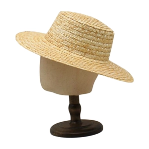 Detailed close-up of fine straw weave texture on a minimalist wide-brim sun hat