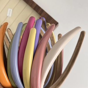 Close-up of colorful glossy headbands showing vibrant variety of shiny fashion hair hoops