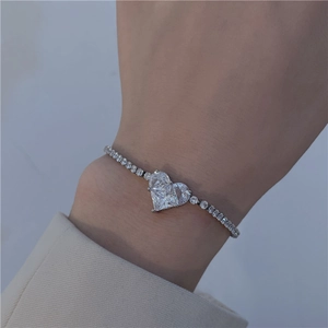 Close-up of elegant silver heart-shaped zircon bracelet on a woman's wrist