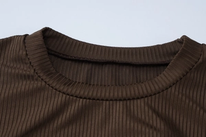 Detailed close-up of dark brown knit crewneck neckline showing ribbed texture and stitching