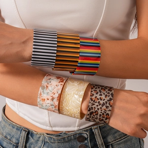 Chic wide acrylic resin cuff bracelets with marble and stripe patterns on a model
