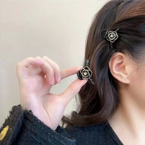 Elegant mini camellia hair claw clips with rhinestones shown on hair for a stylish look