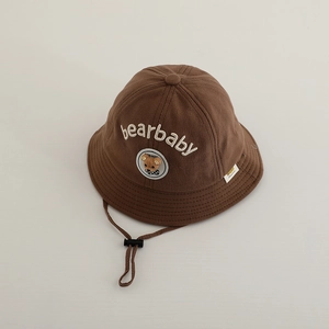 Detailed embroidery of bearbaby letters and cartoon bear patch on brown bucket hat