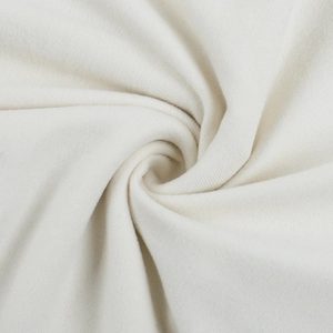 Close-up of high-quality cream white knitted fabric showing soft texture and weave detail