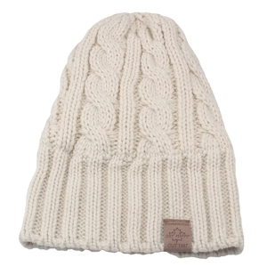 Close-up of beige cable knit beanie with thick texture and a brown leather logo patch