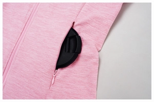 Close-up of pink athletic jacket showing hidden zipper pocket and textured fabric