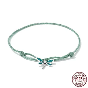 Adjustable green cord bracelet with silver dragonfly charm and green enamel details