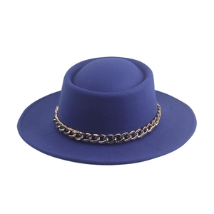 Close-up of blue felt fedora featuring a bold gold chain link decorative hatband