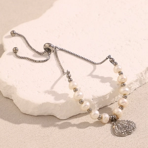 Detail of adjustable pearl shell pendant bracelet with sparkling rhinestones and box chain