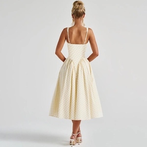 Detail view of yellow plaid dress showing the back zipper and flattering waistline
