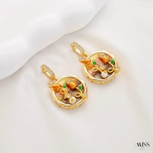 Macro detail of tulip pendant with white pearl and green enamel on silk background