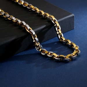 Detailed close-up of hiphop style necklace with gold and silver interlocking metal links