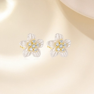 Detail of s925 silver flower stud earrings with white petals and zircon center