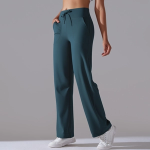 Detail of high waisted drawstring yoga pants with side pockets in dark teal color