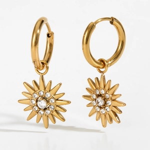 Golden stainless steel hoop earrings with sparkling zircon sun pendants on white background